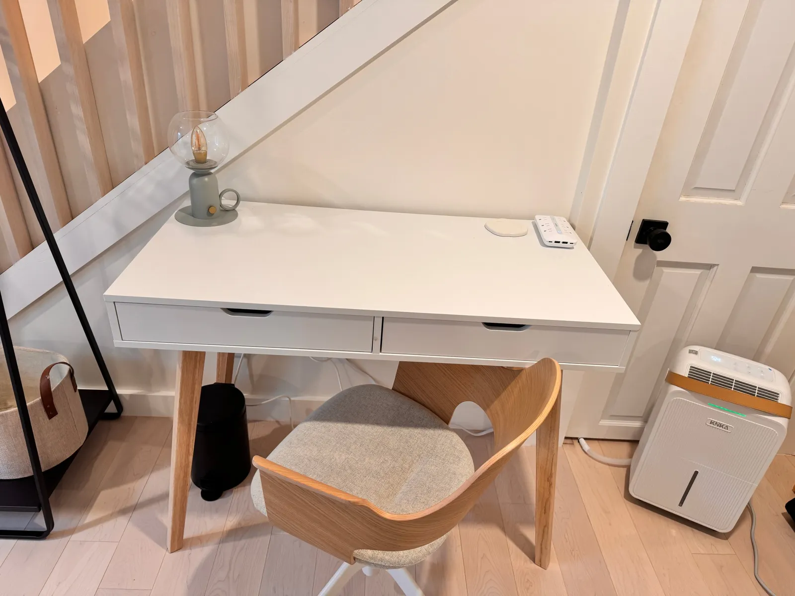 Work-from-home desk tucked under the stairs