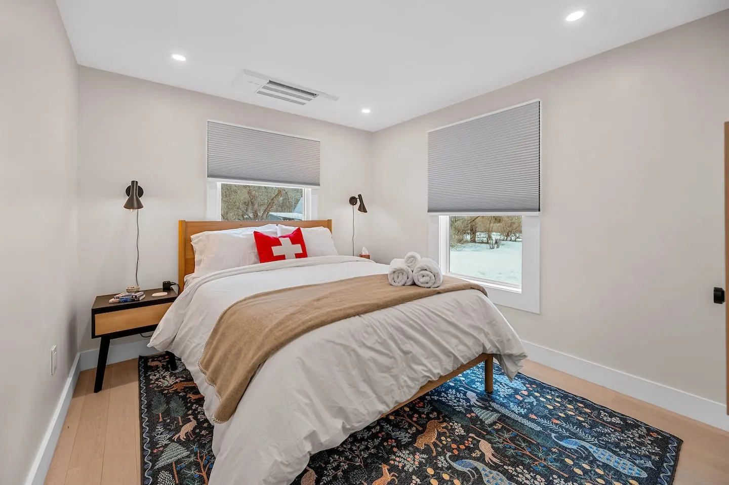 Bedroom 2 with a queen bed and patterned rug