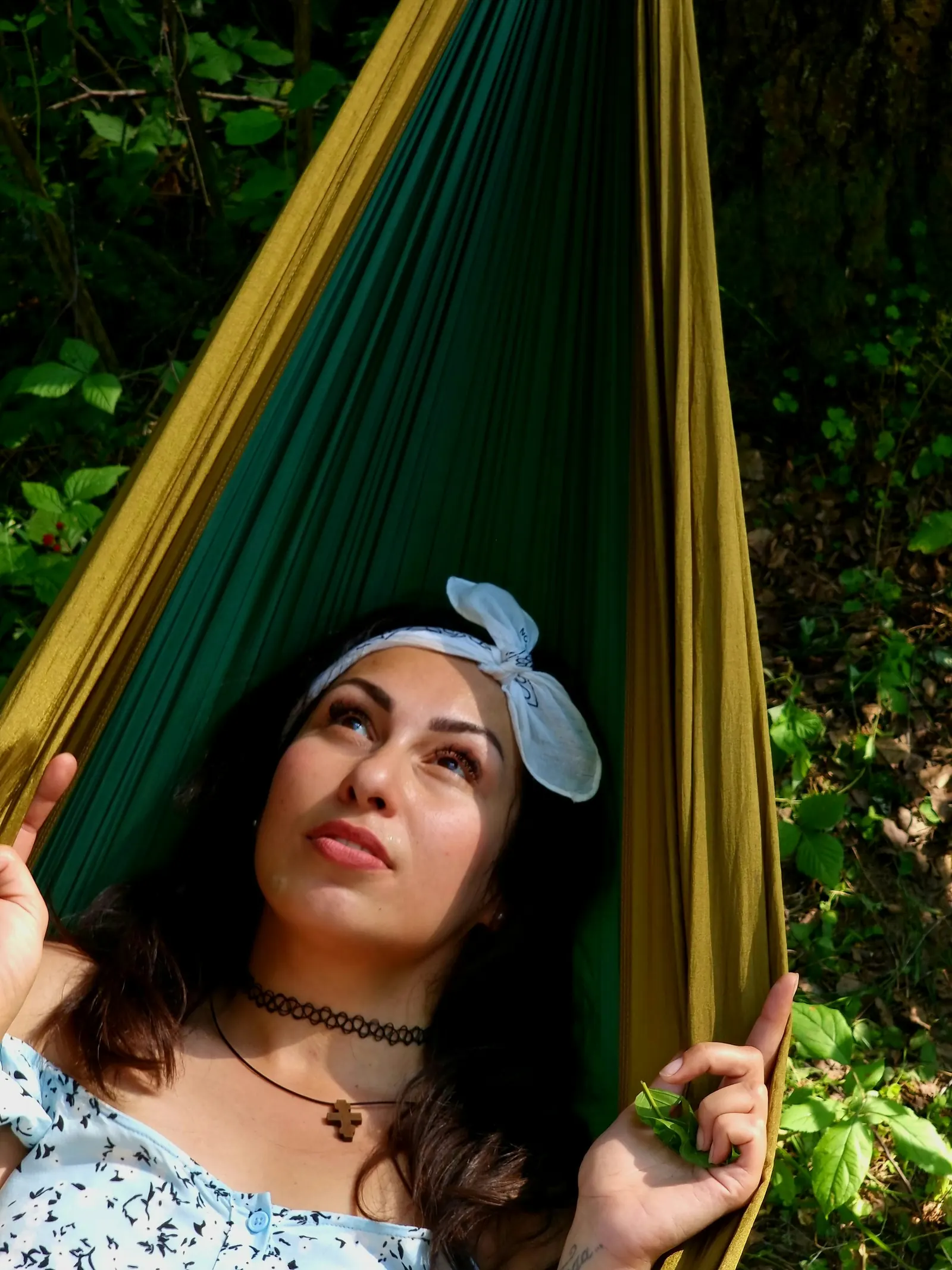 Person relaxing in a hammock outdoors