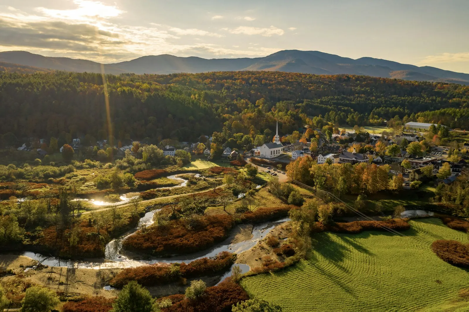 Aerial view of a Vermont valley village surrounded by mountains
